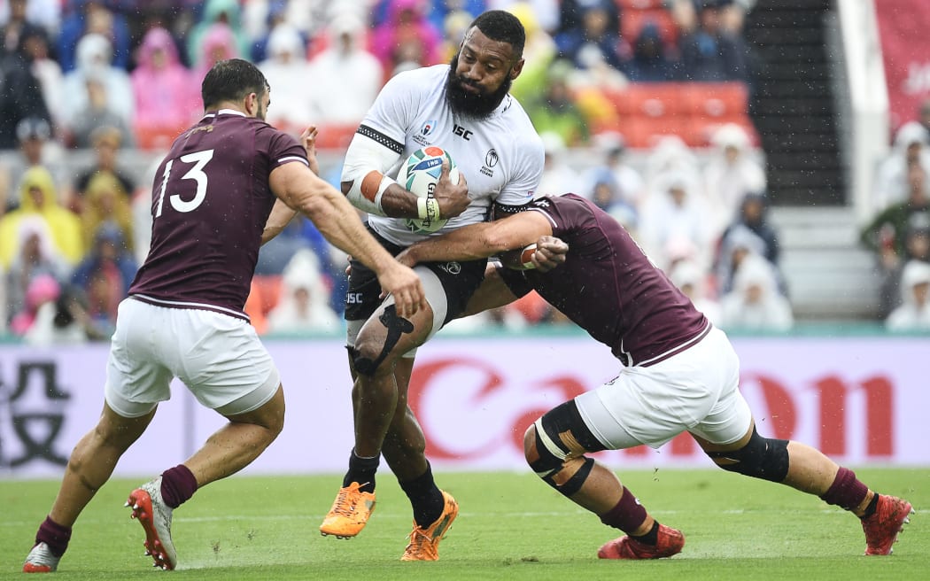 Fiji's centre Waisea Nayacalevu (C) is tackled by Georgians Davit Kacharava and Merab Sharikadze.