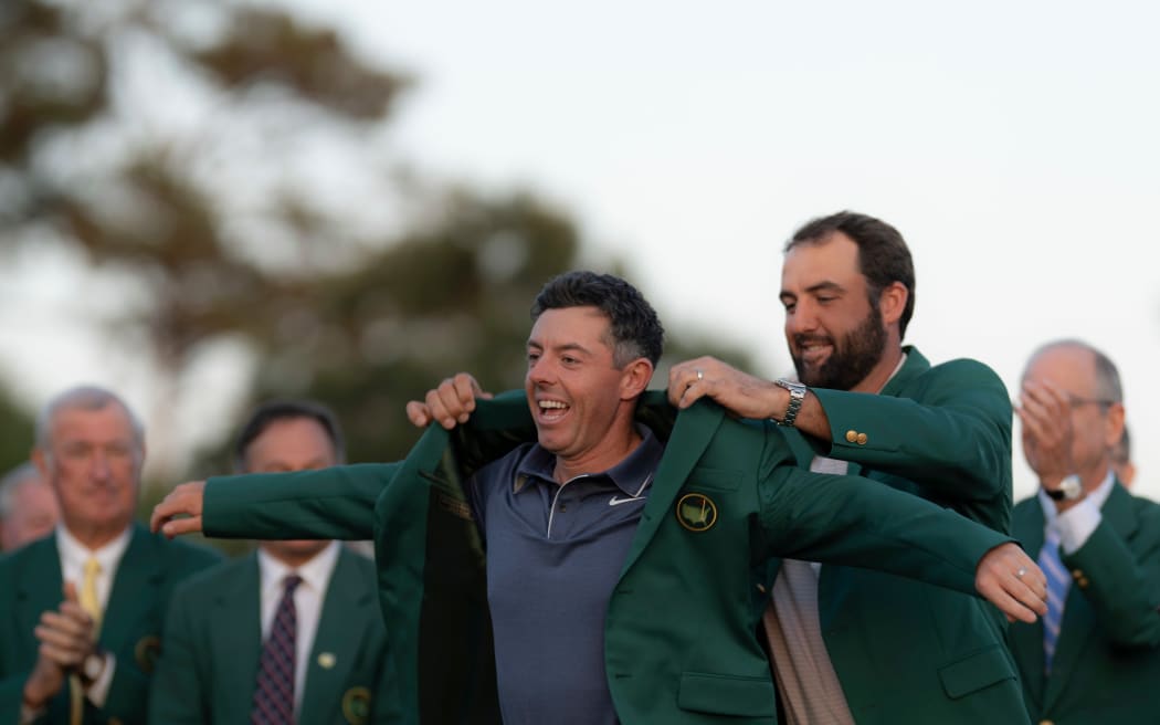 Rory McIlroy is awarded the green jacket after winning the US Masters.