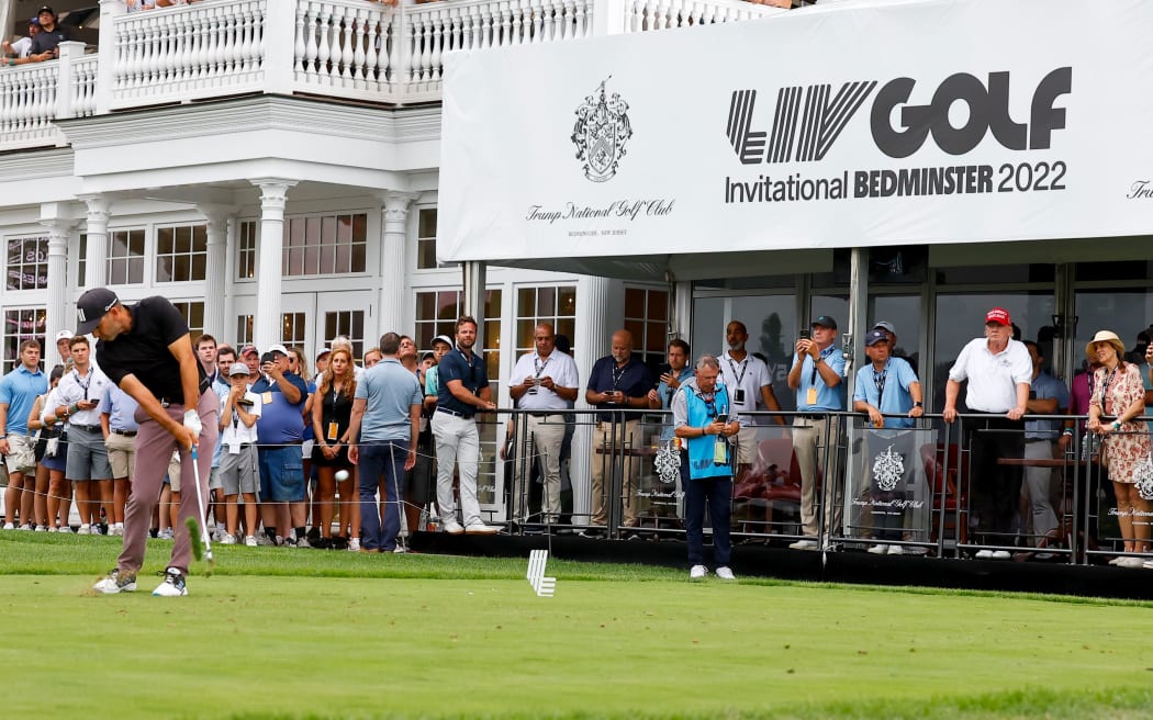 Former President Donald Trump watches as Sergio Garcia of Spain tees off during LIV Golf Invitational Series in New Jersey 2022.