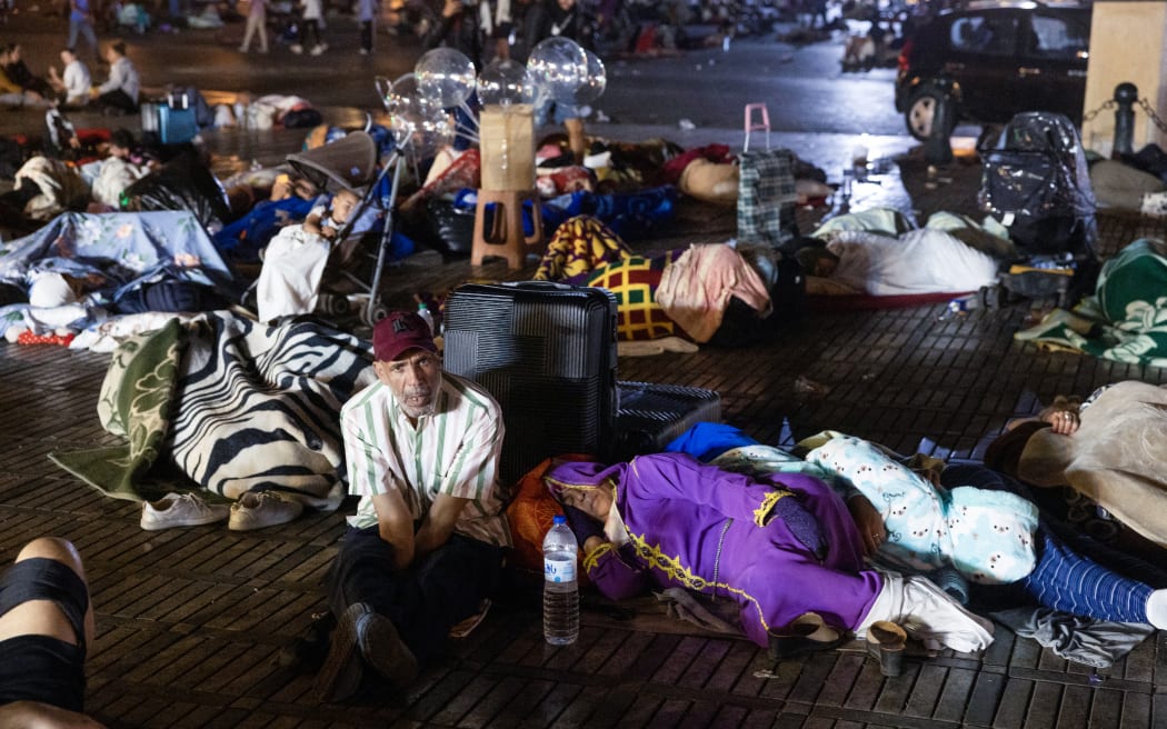 Residents take shelter ouside at a square following an earthquake in Marrakesh on September 9, 2023. Nearly 300 people were killed after a powerful earthquake rattled Morocco on September 8 night, according to a preliminary government count, with Marrakesh residents reporting "unbearable" screams followed the 6.8-magnitude quake. (Photo by Fadel SENNA / AFP)