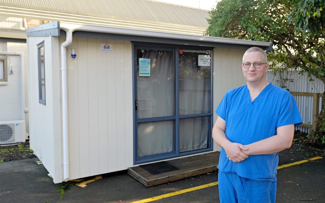 Dr Wim Ruelens outside the relocatable cabin at The Doctors on Desmond Road in Gisborne in June 2023, where sewage issues have caused major disruptions to the business. The cabin, usually used for possible Covid-19 cases, is being used as a temporary clinic.