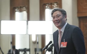 Chinese Minister of Commerce Wang Wentao prepares to leave after giving an interview via video link following the second plenary meeting of the fourth session of the 13th National People's Congress (NPC) in Beijing, capital of China, March 8, 2021.