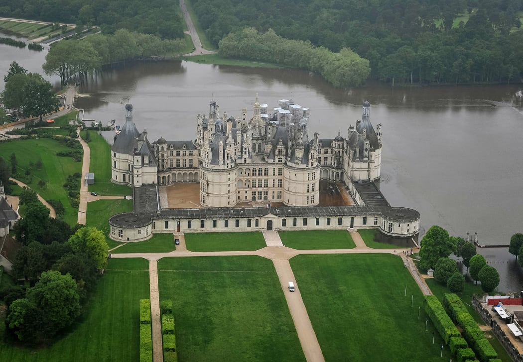 Chambord castle, a UNESCO world heritage site, surrounded by water.