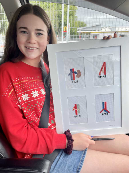 Jemima Thompson with the embroidery she gave to New Zealand vascular surgeon Chris Holdaway. It depicts the four types of Vascular Abdominal Compression syndromes.