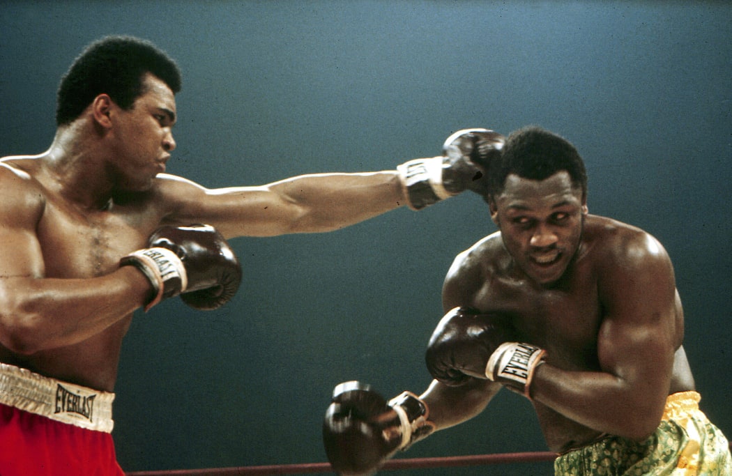 Muhammed Ali (Cassius Clay) punches Joe Frazier during their boxing match, 1971.
