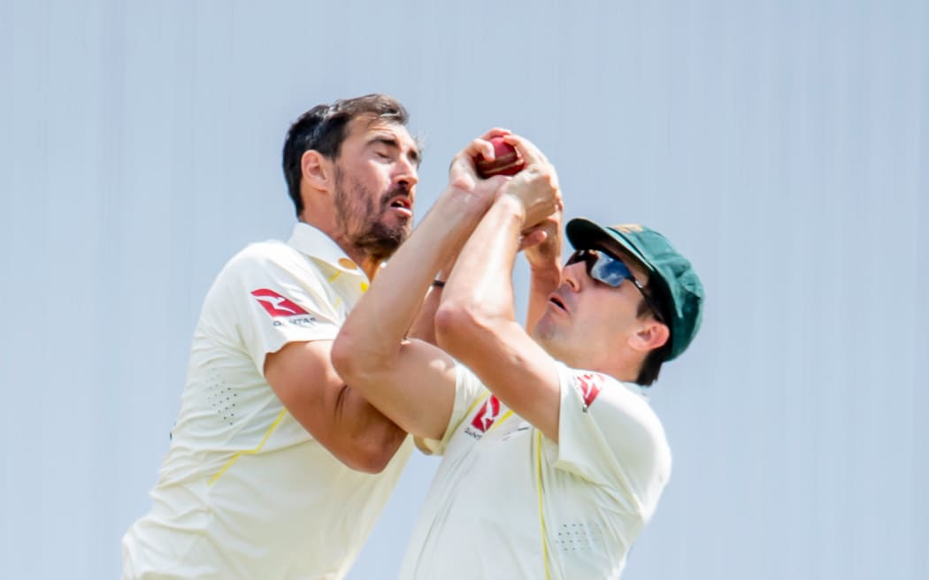 Mitchell Starc (L) and Pat Cummins.