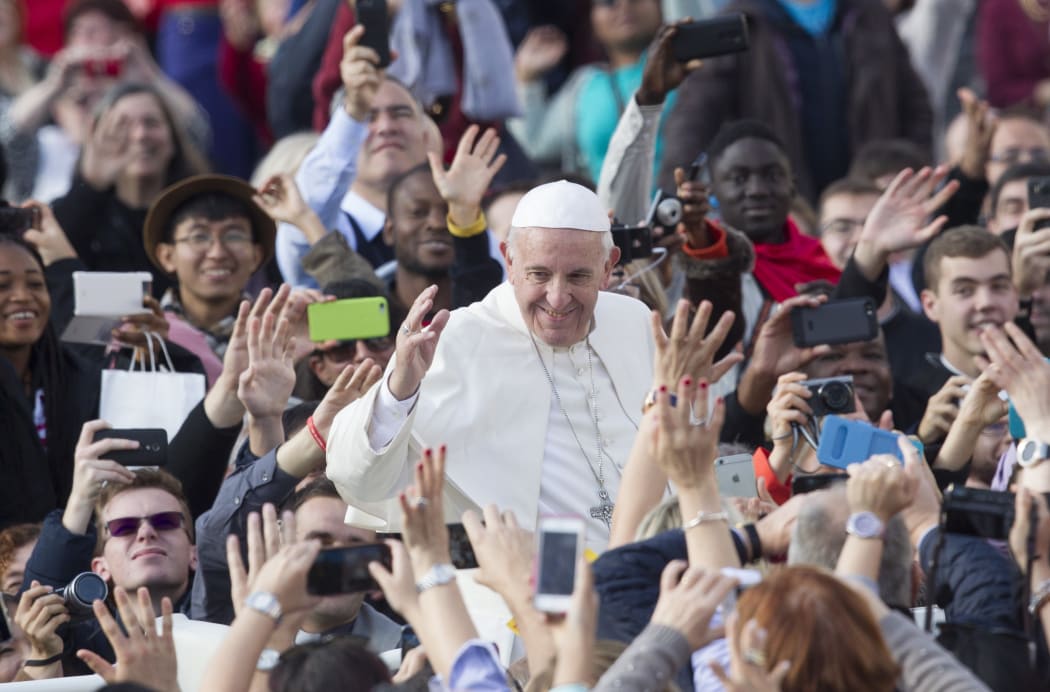 Pope Francis waves to faithful at the end of a Mass for the conclusion of the Jubilee of Mercy, in St. Peter's Square in Vatican.