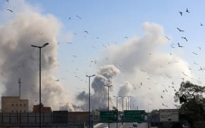 A plume of smoke rises after a strike on the Iranian capital of Tehran on March 5, 2026. Israel pounded Tehran with fresh strikes and Iran targeted Kurdish guerilla groups in Iraq on March 5 as a spiralling war in the Middle East engulfed the entire region. (Photo by ATTA KENARE / AFP)