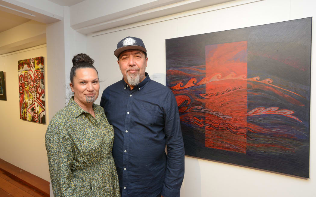 Curators Darryl Thomson and Kirsty Babington in front of 'Revenge of Tawhirimatea' by Sandy Adsett
