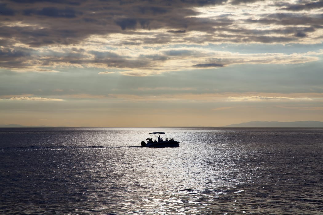 Fishing boat alone in sea.