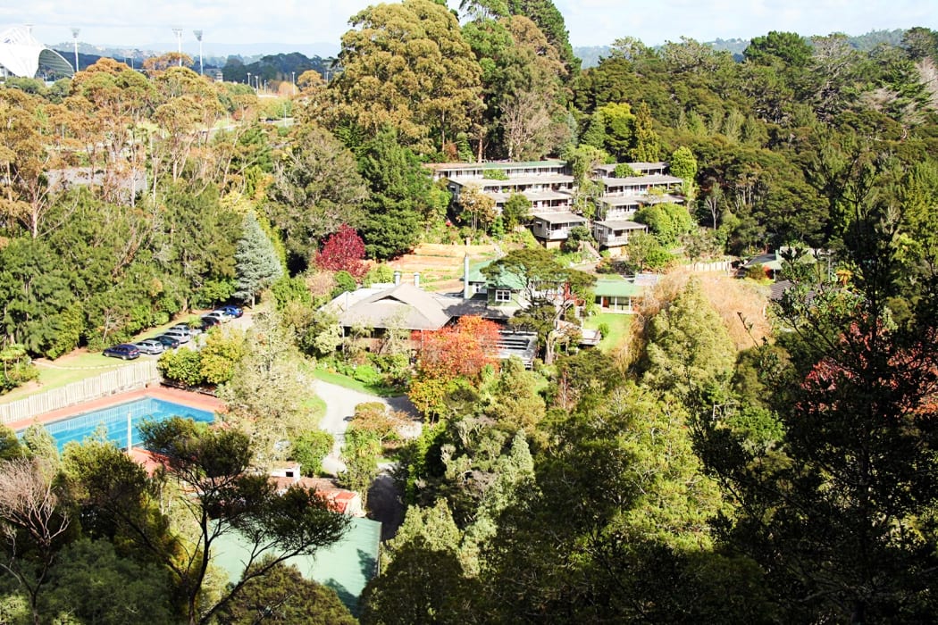 An aerial photo of Kāwai Purapura shows the dozens of buildings built by the Centrepoint community, and North Harbour Stadium in the top left corner.