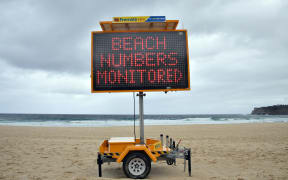 A public health order notice is seen at an almost empty Bondi Beach on Christmas Day in Sydney