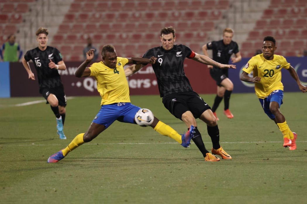 Solomon Islands defender Leon Kofana and New Zealand striker Chris Wood battle for possession.