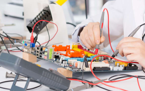 A high school student working on robotics