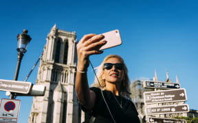 On the first weekend after the fire that devastated Notre-Dame de Paris Cathedral, tourists swarmed in front of the historic monument and took selfies.