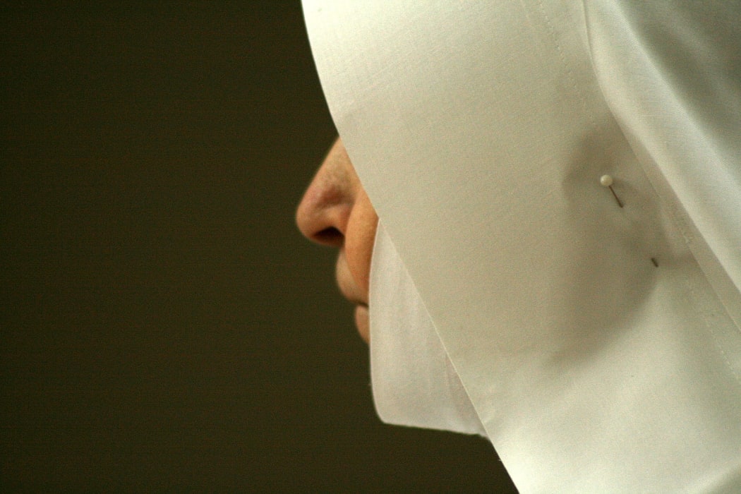 Christian nun, heavily veiled, seen in profile