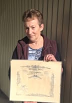 Jean Cretney from Carterton holding the certificate recording the death of her uncle George Carswell.