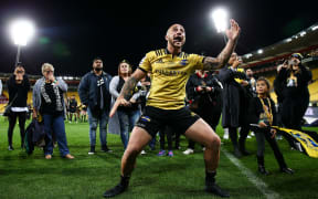 TJ Perenara of the Hurricanes responds to a haka from supporters in recognition of his 100th game.