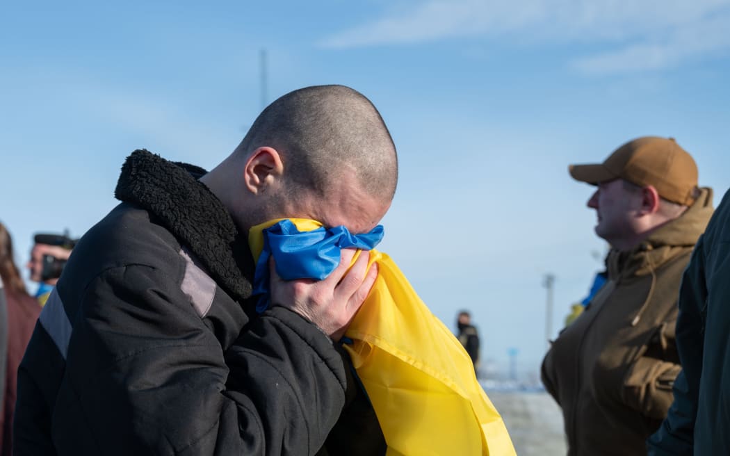 One Ukrainian soldier was seen kissing the country's national flag after the reported prisoner exchange.