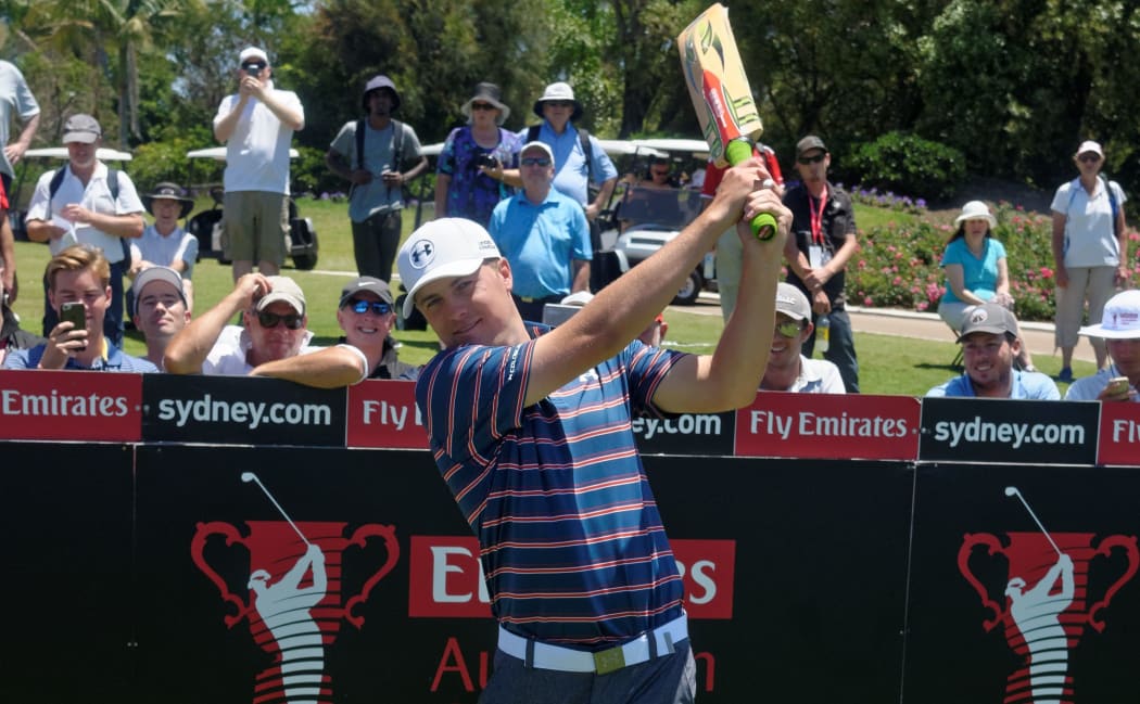 Jordan Spieth tries a cricket bat in Australia, November 2015.