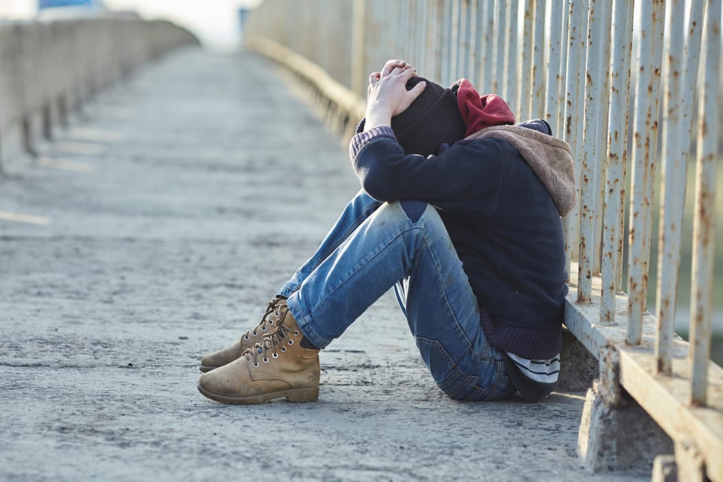 young homeless boy sleeping on the bridge, poverty, city, street