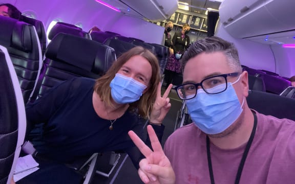 RNZ journalist Tess Brunton and videographer Simon Rogers on board the first flight from Auckland to Sydney after the trans-Tasman bubble opened.