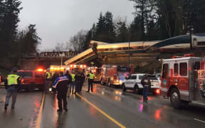 The train fell from an overpass on to a motorway in Washington State.