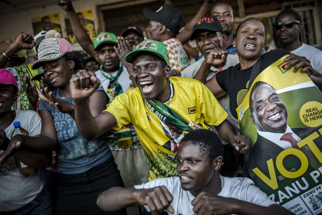 Supporters of the newly reelected Zimbabwe President Emmerson Mnangagwa, celebrate in Mbare, a district of the Zimbabwe's capital Harare.