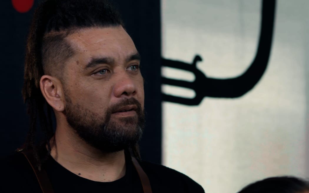 Chop takes a moment to listen to Kīngi's kōrero