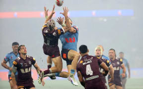 Blues' Zac Lomax (R) and Maroons' Kalyn Ponga contest a high-ball during game two of the men's State of Origin series between the Queensland Maroons and New South Wales Blues at Optus Stadium in Perth on June 18, 2025.