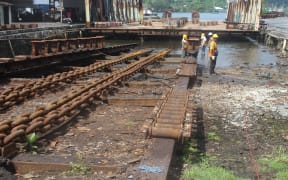 Shipyard workers conducting repairs to the 3,000 ton slipway in American Samoa
