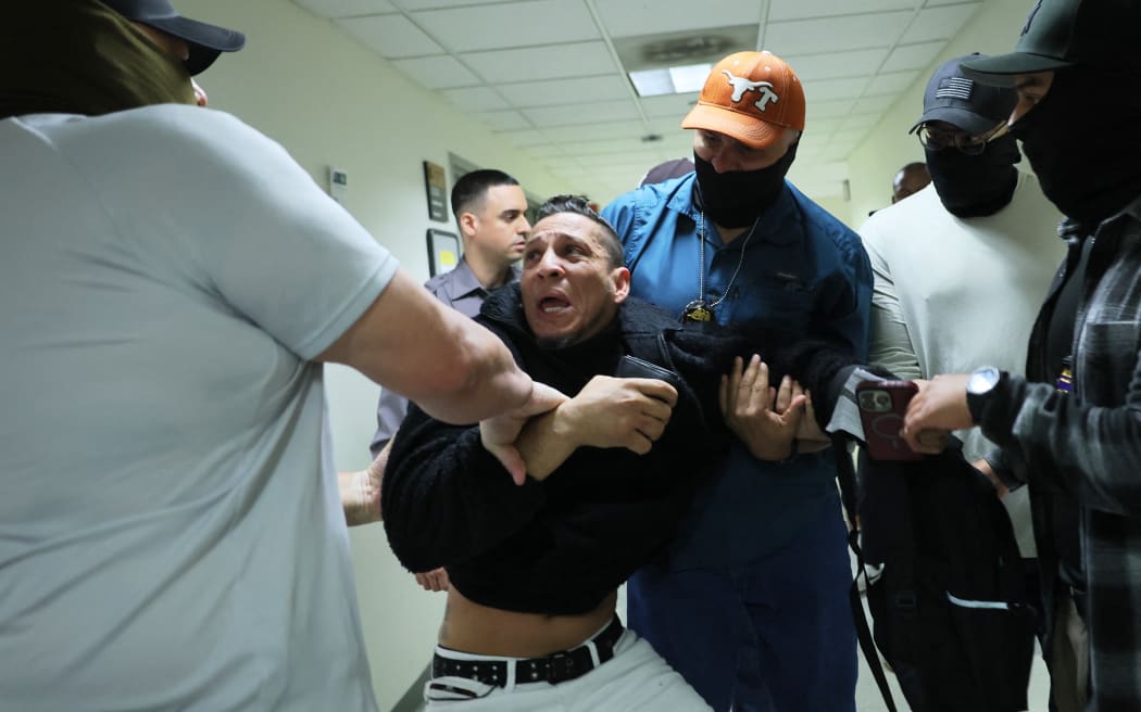 NEW YORK, NEW YORK - OCTOBER 27: A man seeking asylum from Colombia is detained by federal agents as he attends his court hearing in immigration court at the Jacob K. Javits Federal Building on October 27, 2025 in New York City. Immigration and Customs Enforcement (ICE) agents and other federal agencies continue to detain people in immigration courts as they attend their court hearings, despite a government shutdown that is now in its 27th day, the second-longest shutdown in U.S. history.   Michael M. Santiago/Getty Images/AFP (Photo by Michael M. Santiago / GETTY IMAGES NORTH AMERICA / Getty Images via AFP)