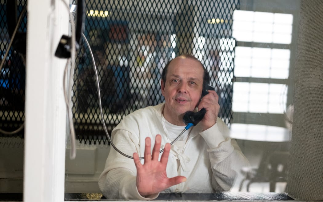 (FILES) This handout image courtesy of the Innocence Project shows Robert Roberson photographed through plexiglass at the Texas Department of Criminal Justice Polunsky Unit in Livingston, Texas, on December 19, 2023. - The Texas pardons board rejected a clemency appeal on October 16, 2024 from Roberson, an autistic man on death row whose murder conviction was based on what his lawyers say was a misdiagnosis of 