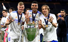 28th May 2022;  Stade de France stadium, Saint-Denis, Paris, France. Champions League football final between Liverpool FC and Real Madrid; Luka Jovic, Toni Kroos and Casemiro of Real Madrid pose with the Champions League trophy