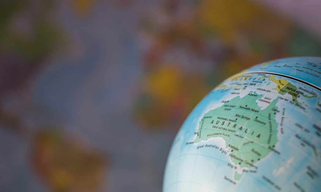 Australia map on a globe with earth map in the background