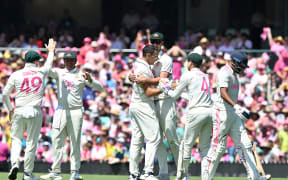 Australia’s Scott Boland, centre, celebrates capturing the wicket of India's Mohammed Siraj during the fifth cricket test at the Sydney Cricket Ground on 5 January, 2025.