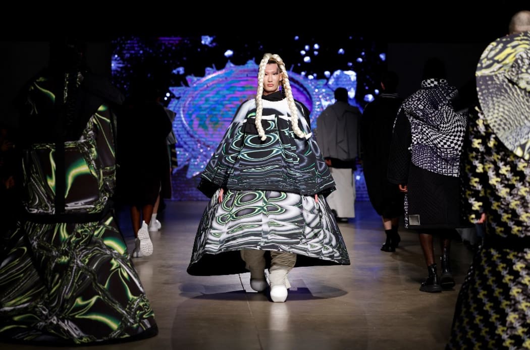A model presents a creation for KWK by Kay Kwok during the catwalk show for their Autumn/Winter 2022 collection on the final day of the London Fashion Week, in London, on February 22, 2022. (Photo by Tolga Akmen / AFP) / RESTRICTED TO EDITORIAL USE