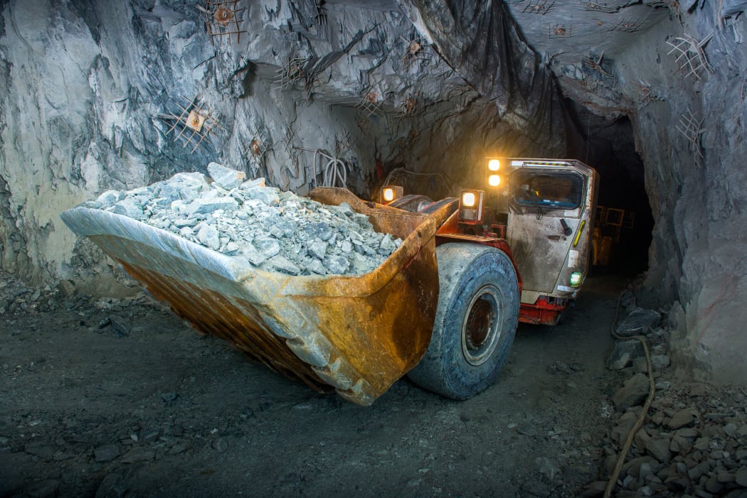 Working inside gold mine tunnel. Gold mining.