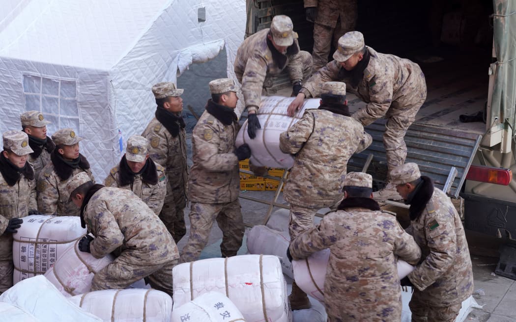 Soldiers transport disaster relief materials for quake-affected residents in Shiyuan Township of Jishishan County, northwest China's Gansu Province, on 22 December, 2023.