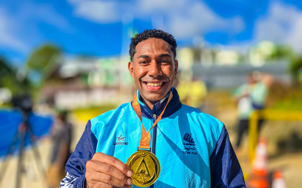 Team Fiji's Errol Qaqa with his gold medal in the men's 110m hurdle.