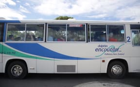 Tourists being taken by bus from Kaikoura to where they can board a navy ship.