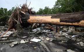 A large tree is uprooted outside of a home near Camp Mystic, the site of where at least 20 girls went missing after flash flooding in Hunt, Texas, on July 5, 2025. Rescuers were on Saturday searching for more than 20 girls missing from a riverside summer camp in the US state of Texas, after torrential rains caused devastating flooding that killed at least 27 people -- with more rain on the way. "So far, we've evacuated over 850 uninjured people, eight injured people and have recovered 27 deceased fatalities at this time. Of these 27, 18 are adults, nine are children," said Kerr Country Sheriff Larry Leitha on July 5. (Photo by RONALDO SCHEMIDT / AFP)
