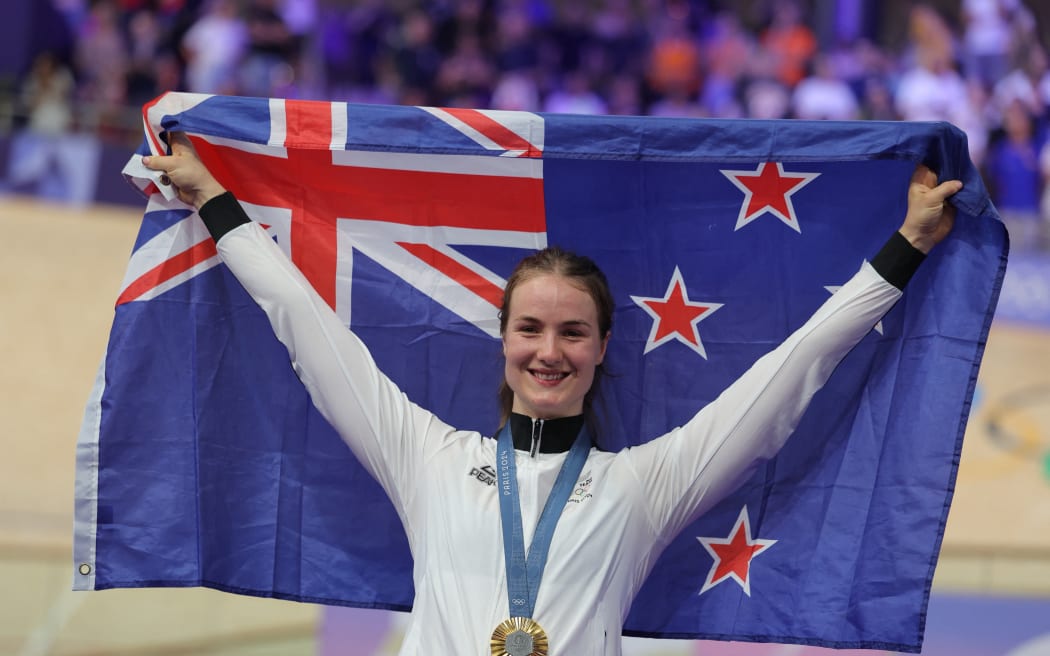 Gold medallist New Zealand's Ellesse Andrews poses on the podium of the women's track cycling keirin event of the Paris 2024 Olympic Games at the Saint-Quentin-en-Yvelines National Velodrome in Montigny-le-Bretonneux, south-west of Paris, on August 8, 2024.