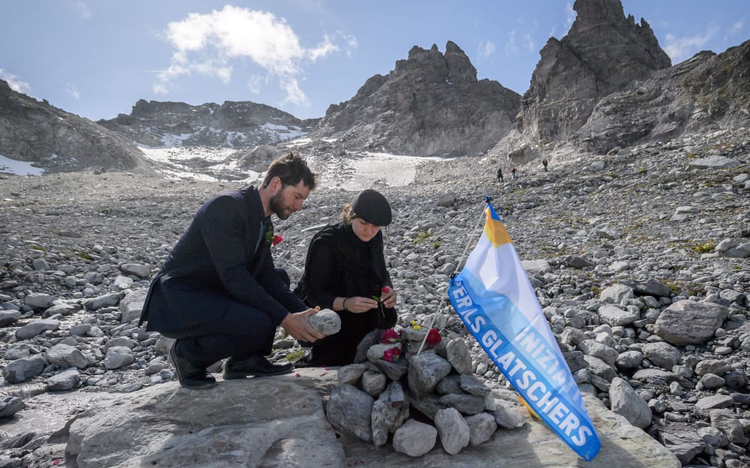 People take part in a ceremony to mark the 'death' of the Pizol glacier (Pizolgletscher) on September 22, 2019 above Mels, eastern Switzerland.