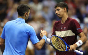 Alexei Popyrin of Australia shakes hands with Novak Djokovic of Serbia after winning their men's singles third round match on day five of the 2024 US Open at USTA Billie Jean King National Tennis Center on August 30, 2024 in the Flushing neighborhood of the Queens borough of New York City.   Sarah Stier/Getty Images/AFP (Photo by Sarah Stier / GETTY IMAGES NORTH AMERICA / Getty Images via AFP)