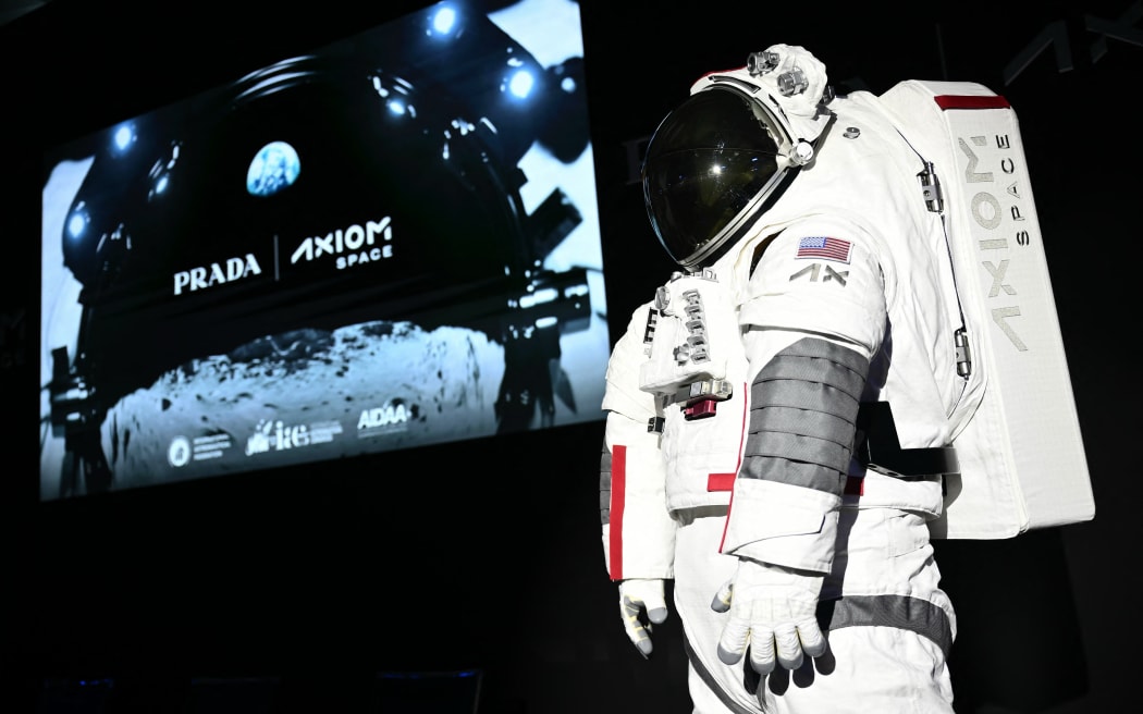 The AxEMU suit is pictured during a press conference of Prada and Axiom Space, as part of the presentation of the Axiom Extravehicular Mobility Unit designed and developed for the Artemis 3 lunar mission in collaboration with Prada, at the MiCo Convention Centre in Milan, northern Italy, on October 16, 2024. - Astronauts walking on the moon as part of NASA's first human mission to the lunar South Pole will be wearing Prada, as part of a new venture unveiled on October 16, 2024. Private space company Axiom Space teamed up with the Italian luxury brand to provide the surface suits and spacewalk systems for NASA's Artemis 3 mission, which is planned for September 2026. (Photo by MARCO BERTORELLO / AFP)