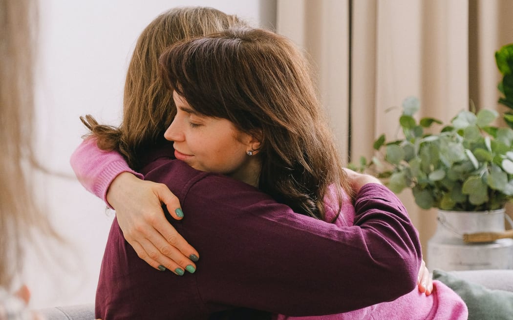 Two women hugging