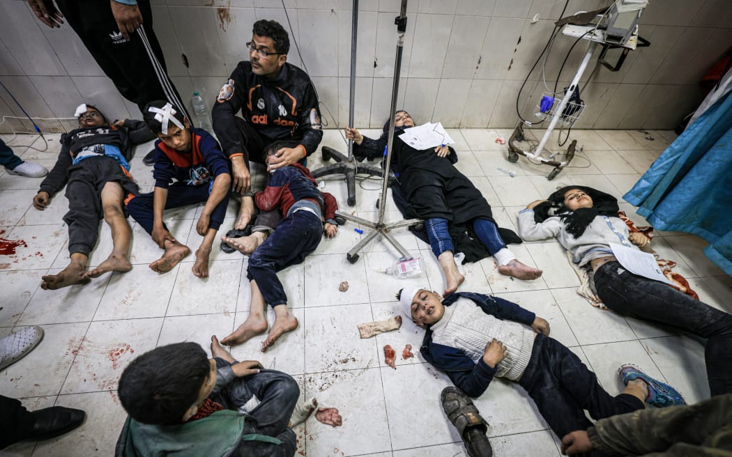 Members of the al-Qedra family, who were injured during Israeli bombardment, receive treatment at Nasser hospital in Khan Yunis on the southern Gaza Strip on 16 December, 2023.