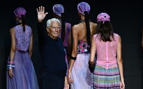 Italian designer Giorgio Armani waves from the runway of the Emporio Armani fashion show during the Milan Fashion Week Womenswear Spring/Summer 2024 on September 21, 2023 in Milan. Italian fashion great Giorgio Armani has died at the age of 91 "surrounded by his loved ones", his company said on September 4, 2025. (Photo by GABRIEL BOUYS / AFP)