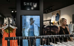 A customer looks at the clothes on display at a pop-up store of the Chinese-founded fast fashion brand Shein, in Dijon, France in June 2025.